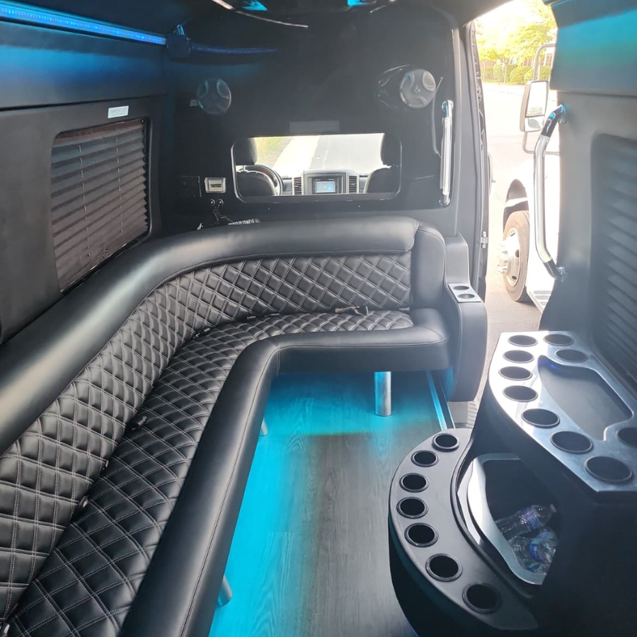 Party Bus Interior with Blue LED Lights and Luxury Leather Seating